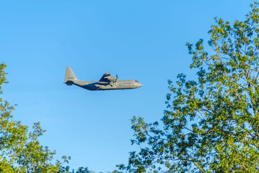 OLDENZAAL, NETHERLANDS - SEPTEMBER 6, 2023:  Low flying C-130H lockheed Martin Hercules of the Dutch Royal Airforce. It is a four-engine turboprop military transport aircraft.