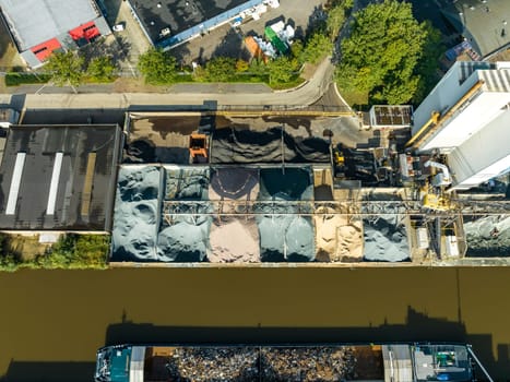 aerial view of an asphalt factory along a canal