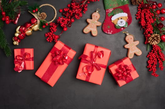 Christmas decor, gift red boxes on a black background, top view. Place for inscription
