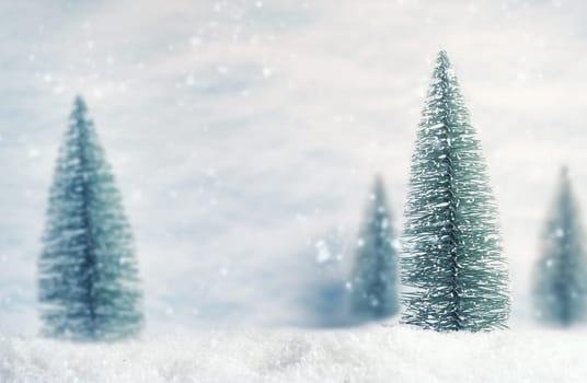 Winter background with a toy Tree in the snow, Christmas or seasonal concept image