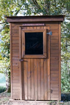 a small wooden cabin in garden.