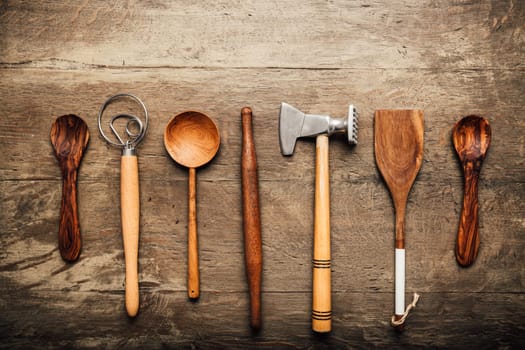 Vintage kitchen utensils (cooking tools) on wooden background