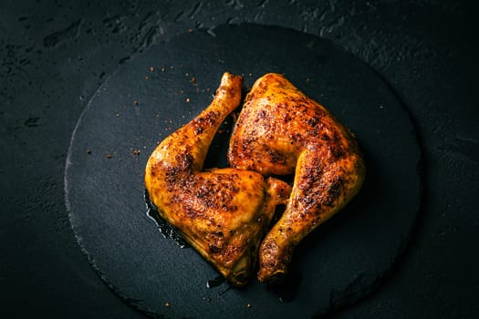 BBQ grilled chicken legs on black background