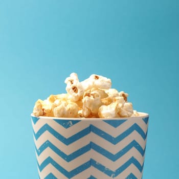 Fresh popcorn on a blue background with space for your text