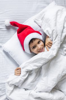 Beautiful child boy playing in decorated home for Christmas, enjoying holidays at home. Generation Alpha and Gen Alpha.