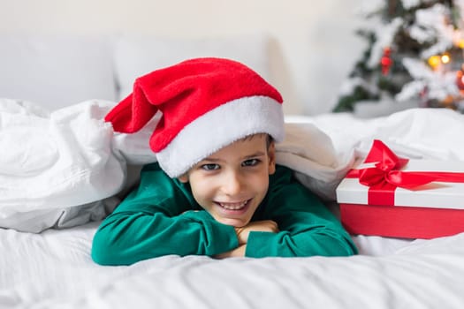 Beautiful child boy playing in decorated home for Christmas, enjoying holidays at home. Generation Alpha and Gen Alpha.