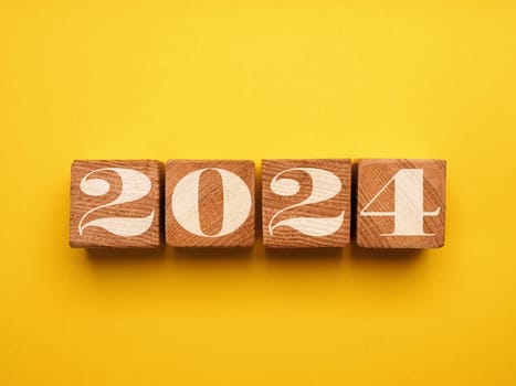 Wooden blocks with the Year number 2024, New Year concept, seasonal Christmas time