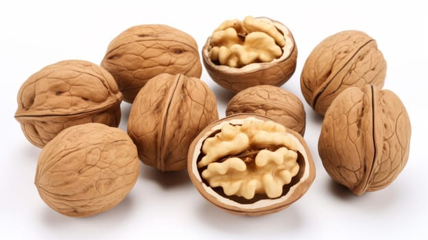 Whole and cracked walnuts isolated on white background. Artificial art.