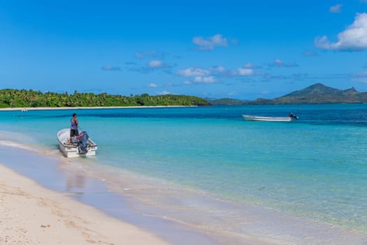 Nacula Fiji: June 25 2023: Man in a boat on the beach waiting for tourists, Yasawa Island group in Fiji