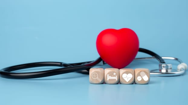 The concept of health insurance and medical welfare. Block wooden and red heart with plus icon. Health insurance and access to health care.