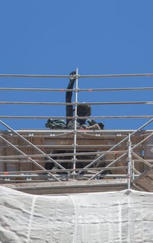 Cornice sculpture covered with scaffoldings. Heritage preservation concept