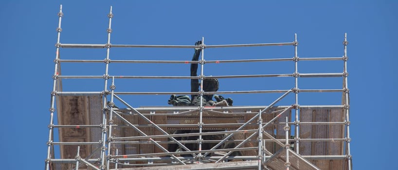Cornice sculpture covered with scaffoldings. Heritage preservation concept