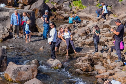 People at the Oxararfoss waterfalls in Iceland. Oxarafoss also called Oxararfoss is located in the Thingvellir National Park on the Oxara River.