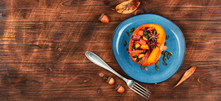 Tasty pumpkin baked with apples, peaches and cinnamon. Autumn recipe, baked squash. Healthy food