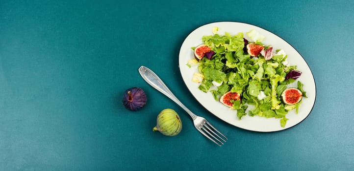 Seasonal fresh colorful salad of green leaves, ripe figs and diet cheese
