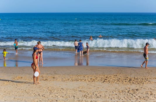 Tavira, Portugal - August 15, 2023: People at the famous beach of Tavira island in Tavira. This beach is a part of famous tourist region of Algarve.
