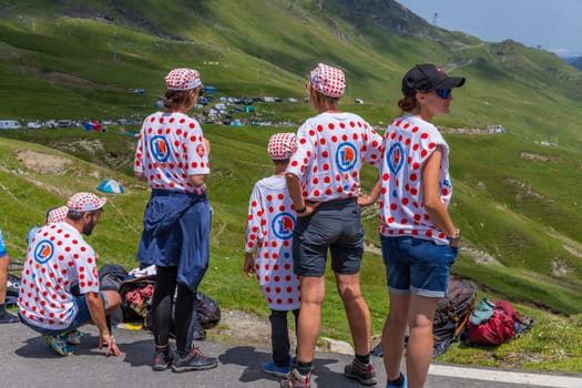 Col du Tourmalet, France - July 06 2023: Cycling fans waiting for the buch at the top of the Col du Tourmalet in Pyerenees mountains during the stage 6 of Le Tour de France 2023