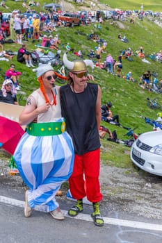 Col du Tourmalet, France - July 06 2023: Cycling fans waiting for the buch at the top of the Col du Tourmalet in Pyerenees mountains during the stage 6 of Le Tour de France 2023