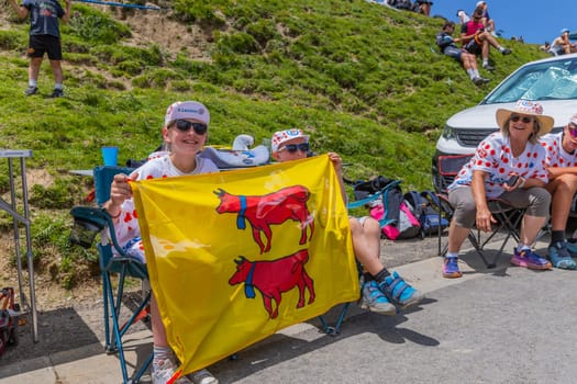 Col du Tourmalet, France - July 06 2023: Cycling fans waiting for the buch at the top of the Col du Tourmalet in Pyerenees mountains during the stage 6 of Le Tour de France 2023