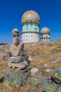 Rocks and transmitting towers with golden cupola, the highest point of Portugal, in Serra da Estrela