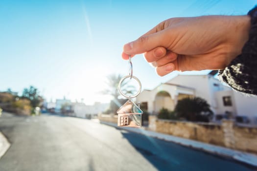 giving house key with a keychain house form