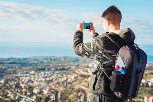 Traveler man taking photographs town with smartphone