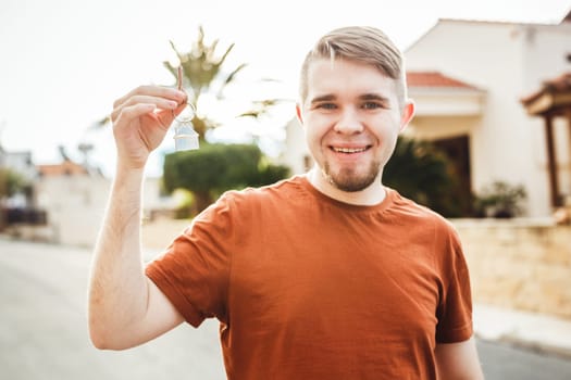 Happy smiling man showing a keys of his new house.