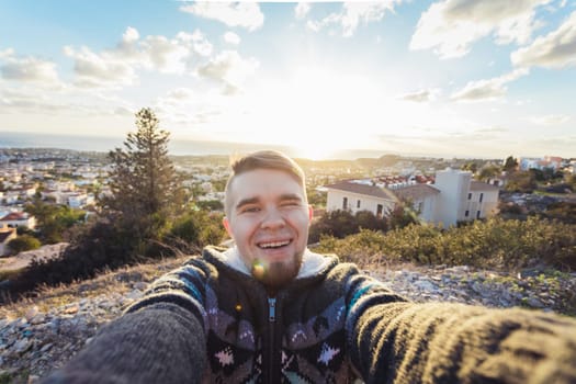 Handsome bearded man taking selfie. Happy student makes funny picture for his blog
