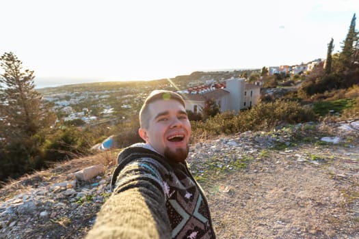 Handsome bearded man taking selfie. Happy student makes funny picture for his blog