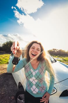 successful beautiful happy woman in the new car with keys - outdoors.