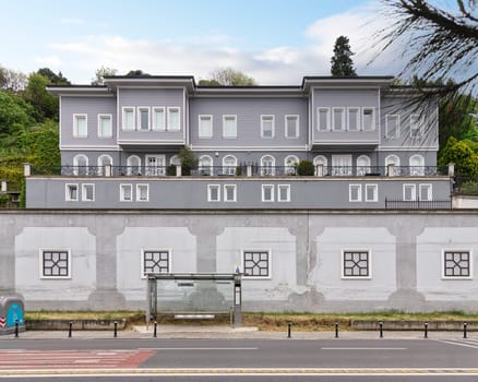 Facade of 19th century Ottoman era Naile Sultan Mansion, a majestic landmark located in Ortakoy neighborhood, Besiktas, Istanbul, Turkey, with Sifa Urdu bus station in front