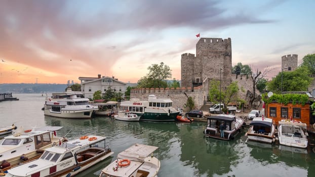 Goksu Stream, with docked group of different shapes, sizes and colors boats, beside Anadolu Hisari historic castle on the Anatolian side of the Bosporus in Beykoz district, Istanbul, Turkey