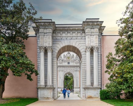 Istanbul, Turkey - May 10, 2023: Entrance of Dolmabahce Palace, with tourists visiting the place - View from the inner courtyard
