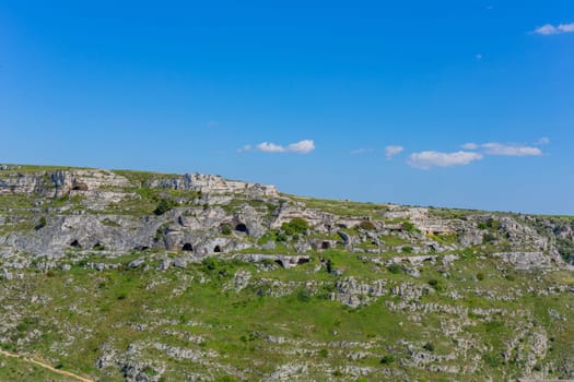 View of Gravina river canyon with the ancient troglodyte caves around Matera in the region of Basilicata, in Southern Italy