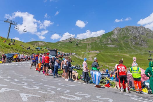 Col du Tourmalet, France - July 06 2023: Cycling fans waiting for the buch at the top of the Col du Tourmalet in Pyerenees mountains during the stage 6 of Le Tour de France 2023