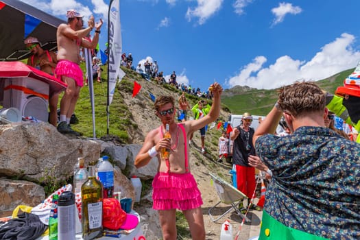 Col du Tourmalet, France - July 06 2023: Cycling fans waiting for the buch at the top of the Col du Tourmalet in Pyerenees mountains during the stage 6 of Le Tour de France 2023