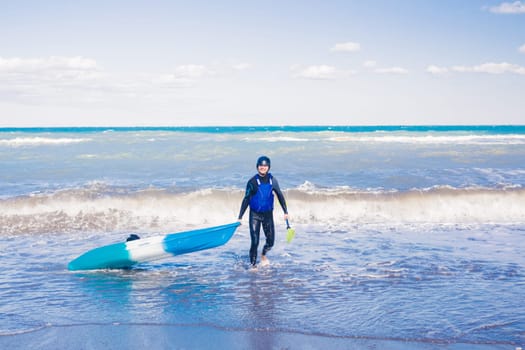 Men by sea kayaking. Traveling by kayak. Leisure activities on the water.