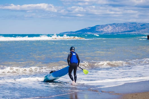 Men by sea kayaking. Traveling by kayak. Leisure activities on the water.