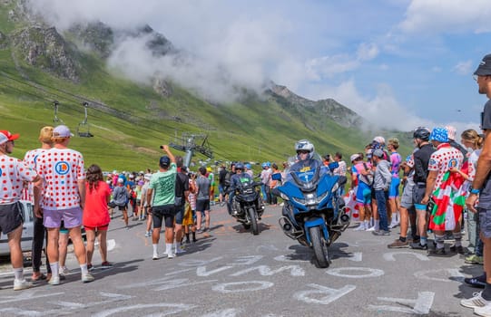 Col du Tourmalet, France - July 06 2023: Cycling fans waiting for the buch at the top of the Col du Tourmalet in Pyerenees mountains during the stage 6 of Le Tour de France 2023