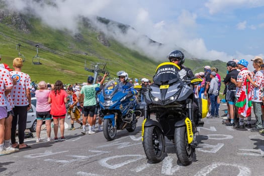 Col du Tourmalet, France - July 06 2023: Cycling fans waiting for the buch at the top of the Col du Tourmalet in Pyerenees mountains during the stage 6 of Le Tour de France 2023