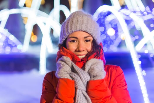 Girl in a night city snowflake Christmas city lights. Christmas and winter holidays.