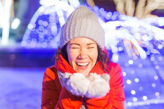 Girl in a night city snowflake Christmas city lights. Christmas and winter holidays.