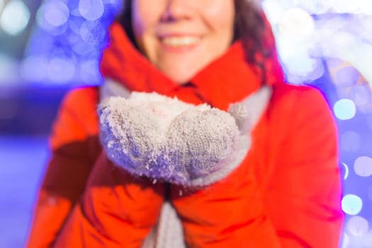 Girl in a night city snowflake Christmas city lights. Christmas and winter holidays.
