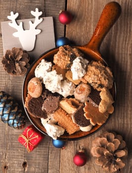 Christmas cookies in a bowl on a wooden table, seasonal or traditional food