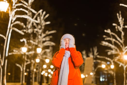 pretty funny girl having fun outdoor in winter. Christmas, city and winter holidays concept.