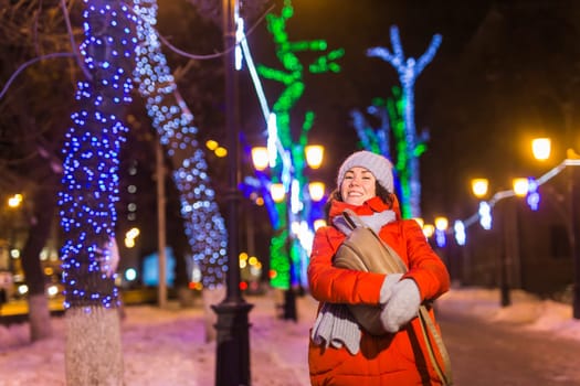 pretty funny girl having fun outdoor in winter. Christmas, city and winter holidays concept.