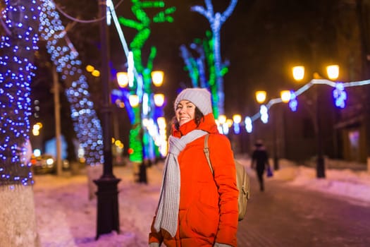 pretty funny girl having fun outdoor in winter. Christmas, city and winter holidays concept.