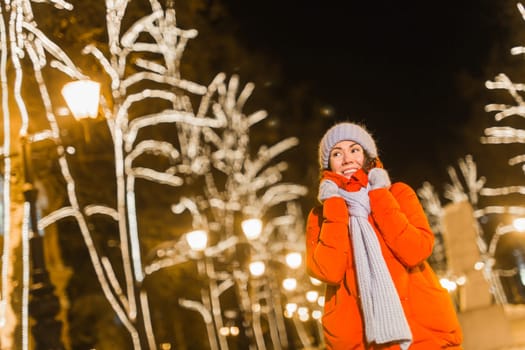 Girl in a night city snowflake Christmas city lights. Christmas and winter holidays.