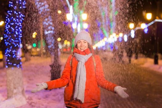 pretty funny girl having fun outdoor in winter. Christmas, city and winter holidays concept.