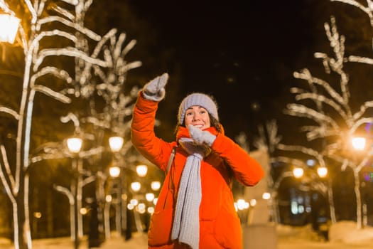 pretty funny girl having fun outdoor in winter. Christmas, city and winter holidays concept.